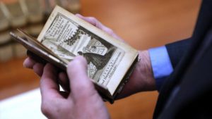 Bob Connors holds an Elzevir edition book