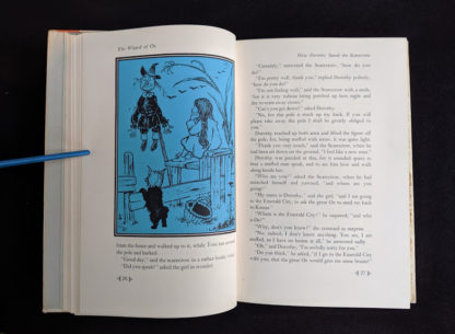 illustration by Denslow of how Dorthy saved the scarecrow in a 1962 copy of The Wizard of Oz published by Macmillan Company